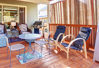 Beautifully designed covered patio with wicker furniture and decorative elements in El Segundo.